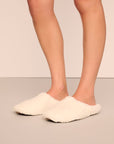 Model is wearing sherpa slipper in ivory