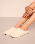 Model is wearing sherpa slipper in ivory