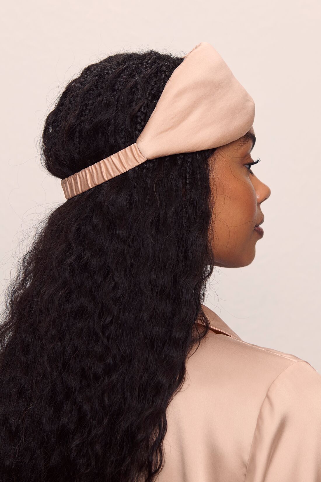 Model is wearing Washable Silk Eye Mask in Rose Cloud