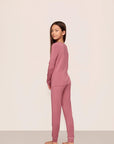 Model is wearing Kids TENCEL™ Modal Unisex Long PJ Set in Berry Blush/Ivory