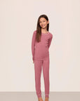 Model is wearing Kids TENCEL™ Modal Unisex Long PJ Set in Berry Blush/Ivory