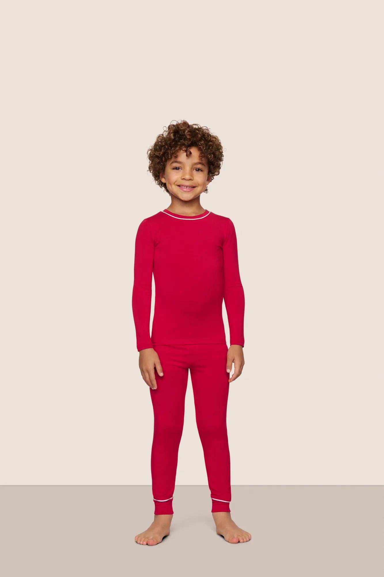 Model is wearing Kids TENCEL™ Modal Unisex Long PJ Set  in Holly Red/Ivory