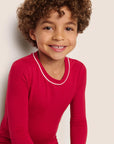 Model is wearing Kids TENCEL™ Modal Unisex Long PJ Set in Holly Red/Ivory