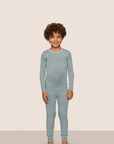 Model is wearing Kids TENCEL™ Modal Unisex Long PJ Set  in Lead/Ivory