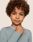 Model is wearing Kids TENCEL™ Modal Unisex Long PJ Set  in Lead/Ivory