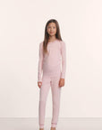 Model is wearing Kids TENCEL™ Modal Unisex Long PJ Set in Pale Pink/Fig