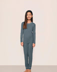 Model is wearing Kids TENCEL™ Modal Unisex Long PJ Set in Stone Blue/Ivory