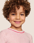 Model is wearing Kids Printed TENCEL™ Modal Unisex Long PJ Set in Duo Stripe Hollyred/Hollyred