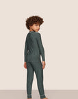 Model is wearing Kids Printed TENCEL™ Modal Unisex Long PJ Set in Duo Stripe Pine/Ivory