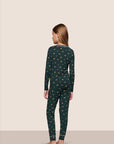 Model is wearing Kids Printed TENCEL™ Modal Unisex Long PJ Set in Holiday Dogs Pine/Ivory