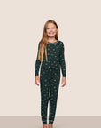 Model is wearing Kids Printed TENCEL™ Modal Unisex Long PJ Set in Holiday Dogs Pine/Ivory