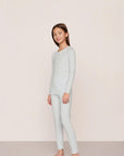 Model is wearing Kids Printed TENCEL™ Modal Unisex Long PJ Set in Large Swans Ice Blue/Ivory