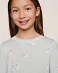 Model is wearing Kids Printed TENCEL™ Modal Unisex Long PJ Set in Large Swans Ice Blue/Ivory