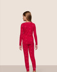 Model is wearing Kids Printed TENCEL™ Modal Unisex Long PJ Set in Nutcracker Holly Red/Ivory