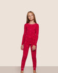 Model is wearing Kids Printed TENCEL™ Modal Unisex Long PJ Set in Nutcracker Holly Red/Ivory