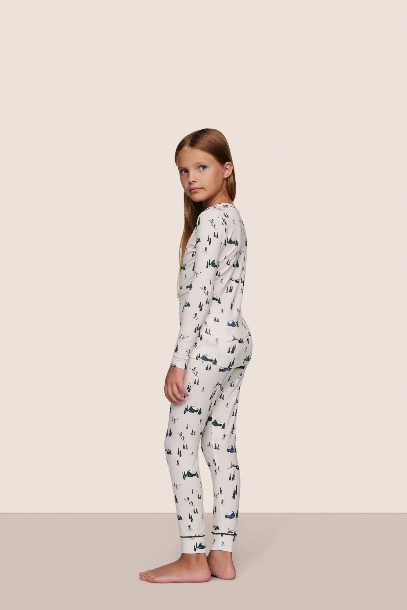 Model is wearing Kids Printed TENCEL™ Modal Unisex Long PJ Set  in Ski Chalet Ivory/Pine