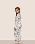Model is wearing Kids Printed TENCEL™ Modal Unisex Long PJ Set in Ski Chalet Ivory/Pine
