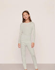 Model is wearing Kids Printed TENCEL™ Modal Unisex Long PJ Set in Tide Dot Ivory/Ivory