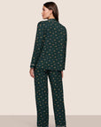 Model is wearing Gisele Printed TENCEL™ Modal Long PJ Set in Holiday Dogs Pine/Ivory
