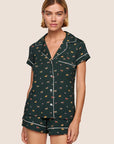 Model is wearing Gisele Printed TENCEL™ Modal Shortie Short PJ Set in Holiday Dogs Pine/Ivory