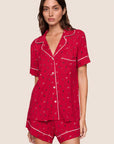 Model is wearing Gisele Printed TENCEL™ Modal Relaxed Short PJ Set in Nutcracker Holly Red/Ivory