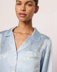 Model is wearing Inez Washable Silk Printed Long PJ Set in Large Swans Powder Blue/Ivory