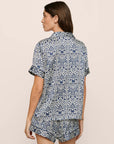 Model is wearing Inez Washable Silk Printed Short PJ Set in Azulejos Navy/Navy
