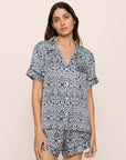 Model is wearing Inez Washable Silk Printed Short PJ Set in Azulejos Navy/Navy