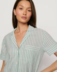 Model is wearing Nautico Shortie Short PJ Set in Regatta Stripe Seagrass/White