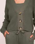Model is wearing Recycled Sweater Cropped Cardigan in Smokey Olive