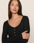 Model is wearing Dream Rib Long Sleeve Henley Tee in Black