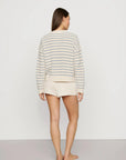 Model is wearing Coastal Cotton Sweater Polo in Regatta Stripe Summer Blue/Whi