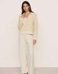 Model is wearing Coastal Cotton Sweater Polo in Stripe Almond Heather/Sunbeam