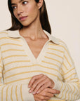 Model is wearing Coastal Cotton Sweater Polo in Stripe Almond Heather/Sunbeam