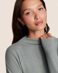 Model is wearing Cozy Time Mock Neck Pullover in Lead