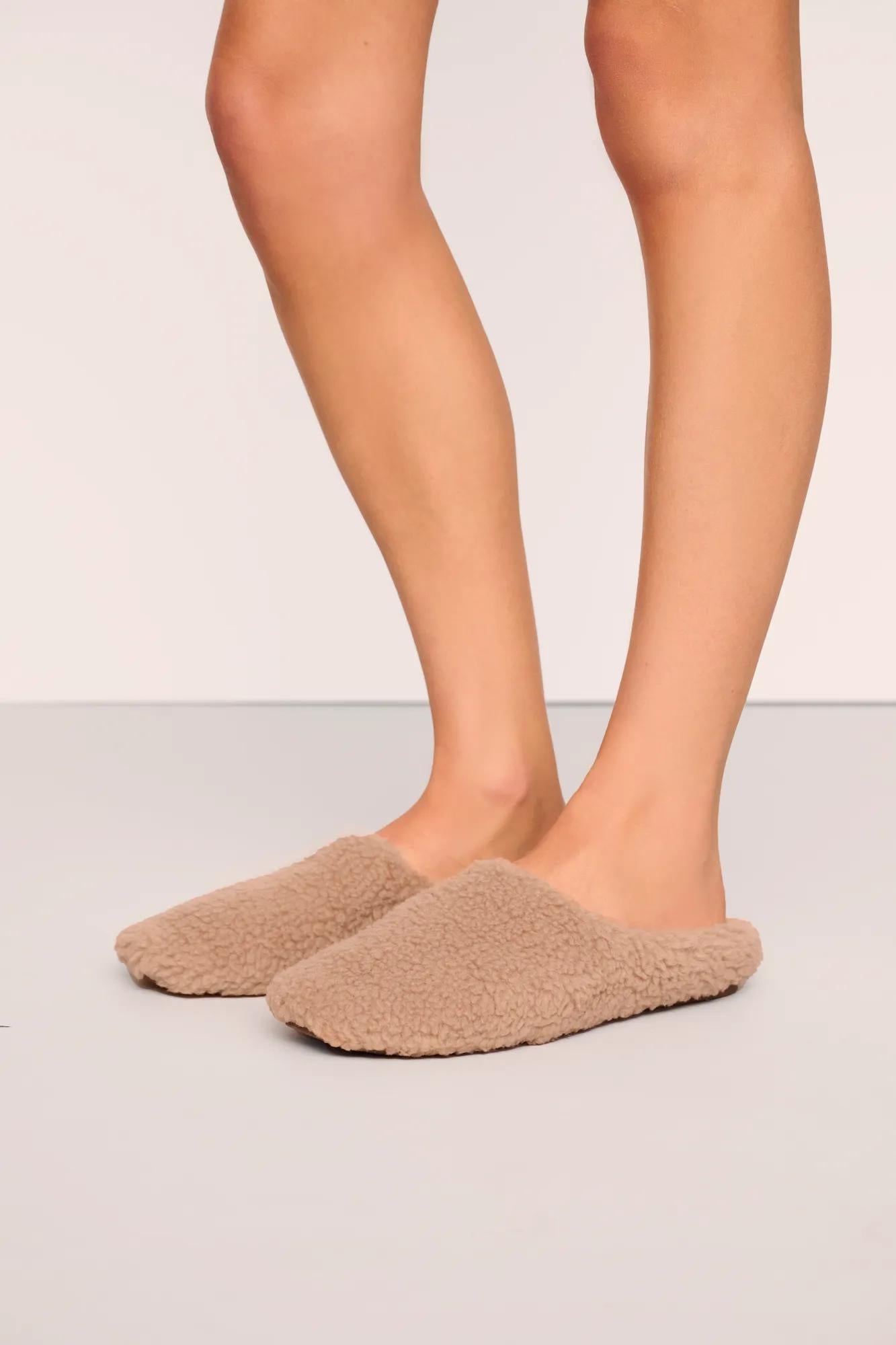 Model is wearing Sherpa Slipper  in  Warm Taupe