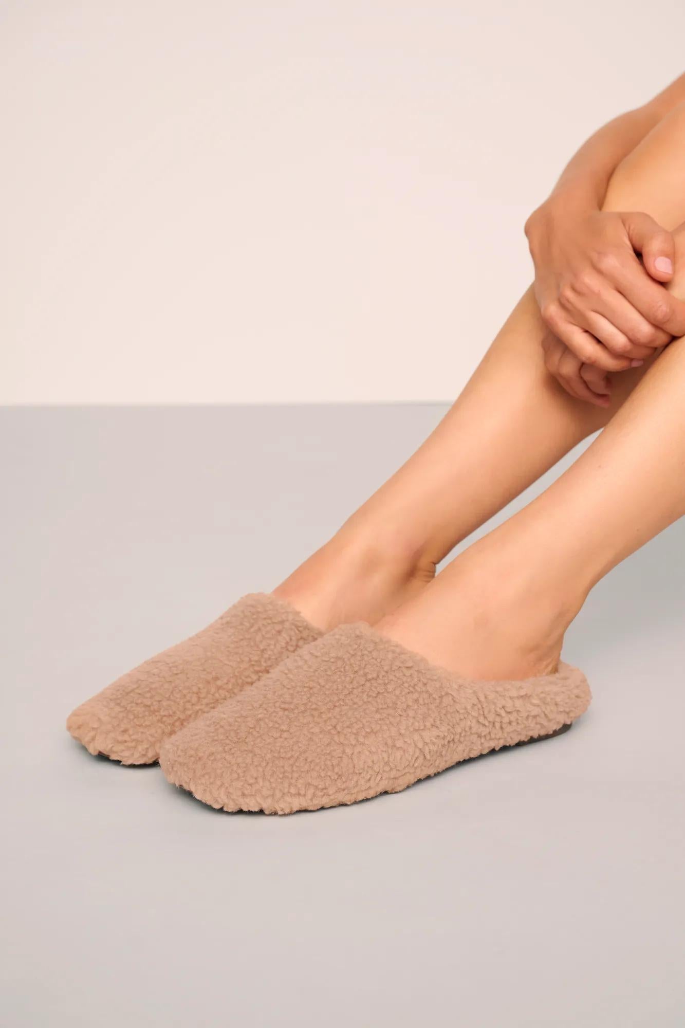Model is wearing Sherpa Slipper  in  Warm Taupe