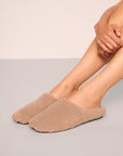 Model is wearing Sherpa Slipper in Warm Taupe