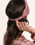 Model is wearing Inez Washable Silk Printed Eye Mask in Bloomscape Misty Rose/Mesa Rose