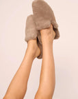 Model is wearing Plush Mule Slipper in Toffee