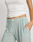 Model is wearing Nautico Boxer Pant in Regatta Stripe Seagrass/White