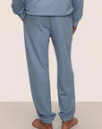 Model is wearing Mens French Terry Jogger in Faded Denim