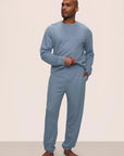 Model is wearing Mens French Terry Jogger in Faded Denim