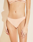 Model wears Pima Stretch Cotton Thong in Buff.