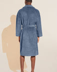 Model wears Terry Gender Neutral Robe in Coastal Blue.