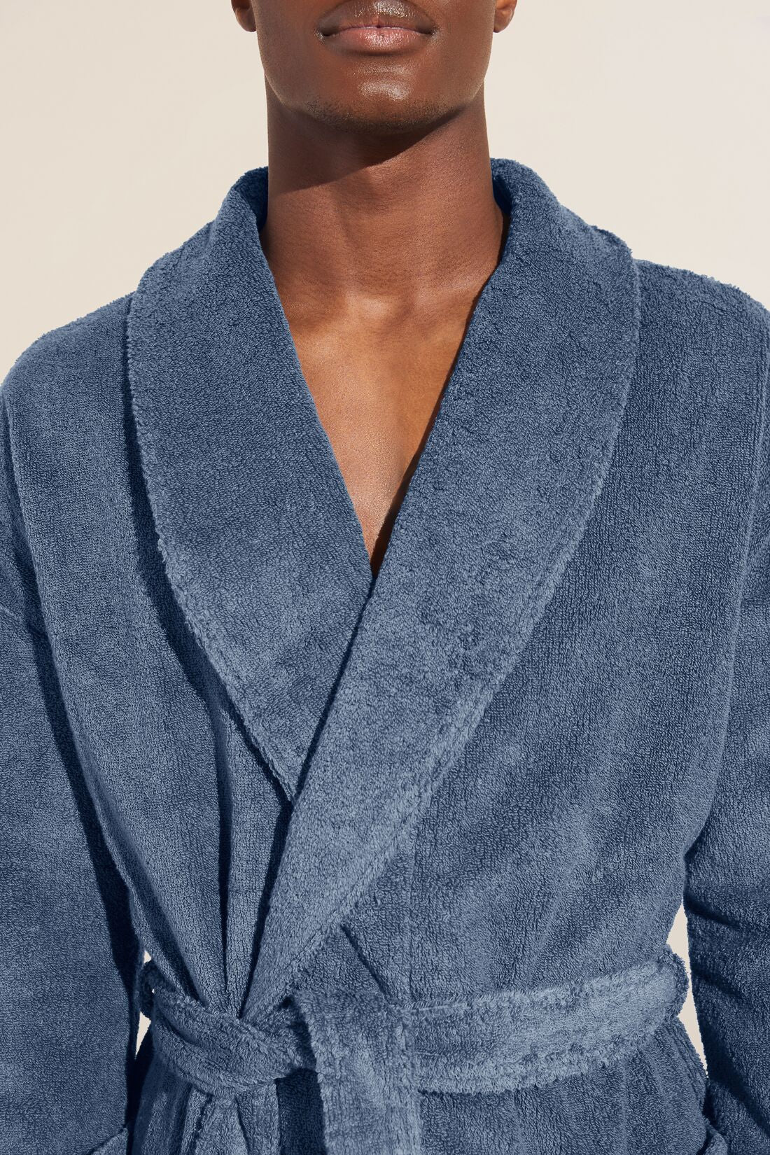 Model wears Terry Gender Neutral Robe in Coastal Blue.