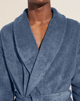 Model wears Terry Gender Neutral Robe in Coastal Blue.