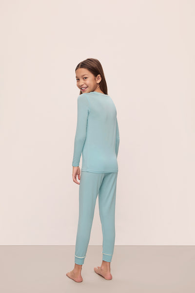 Model is wearing Kids Tencel™ Modal Unisex Long Pj Set in Canal Blue/Ivory