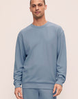 Model is wearing Mens French Terry Sweatshirt in Faded Denim