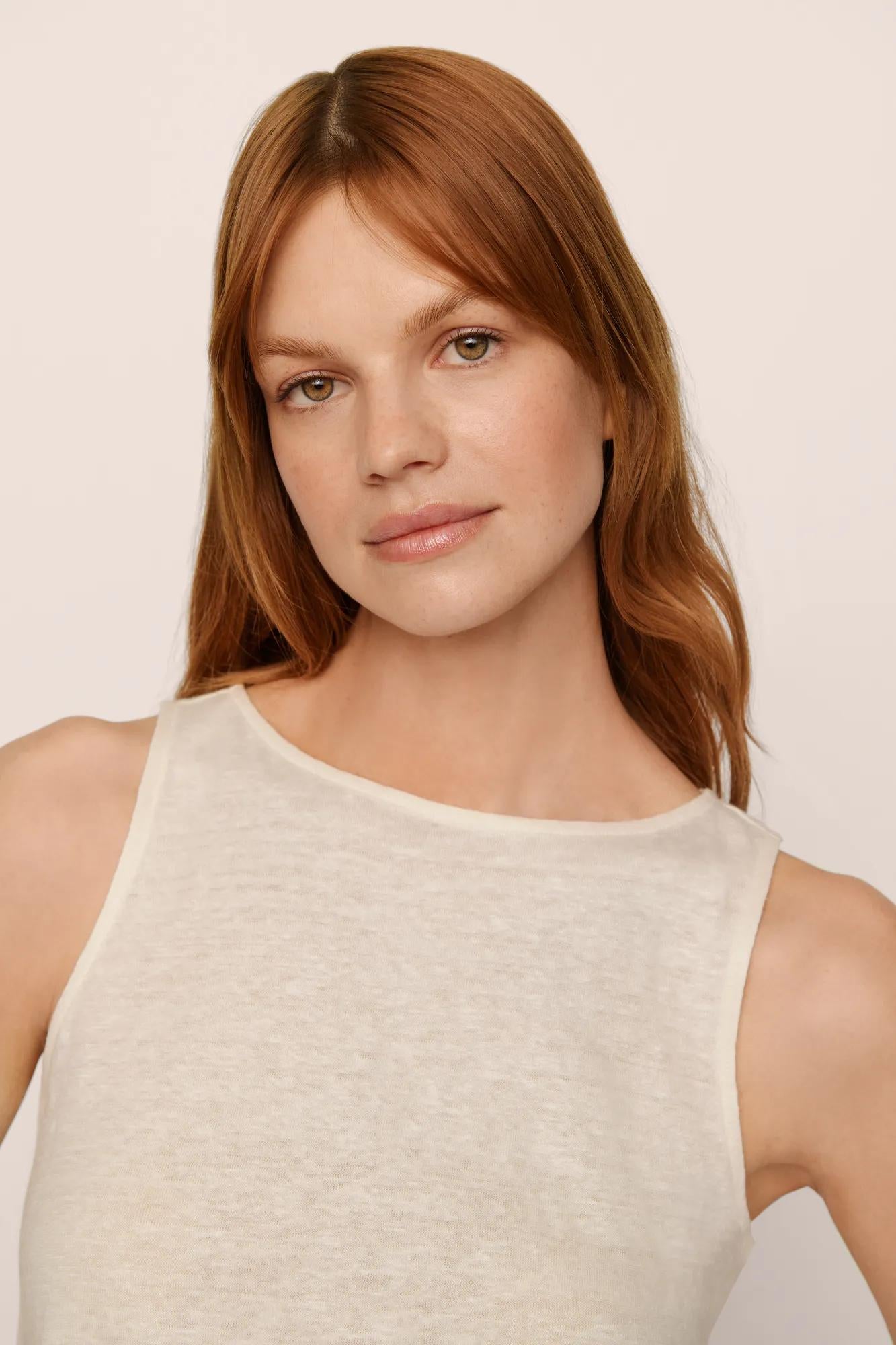 Model is wearing Organic Linen Knit Boat Neck Crop Tank in Ivory